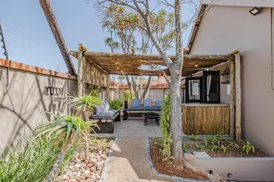a patio with a wooden pergola at Nature's Nest in Pretoria