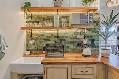 a kitchen with a sink and a laptop on a counter at Nature's Nest in Pretoria