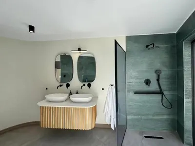 a bathroom with two sinks and a shower at Wabi Sabie River House in Hazyview