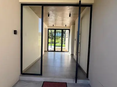 an open door with a mirror in a hallway at Wabi Sabie River House in Hazyview