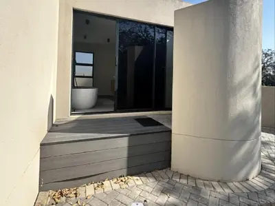 a pivot door of a house with a pillar at Wabi Sabie River House in Hazyview