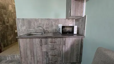 a kitchen counter with a microwave and a sink at The Magalies Nest - Self Catering Accomodation in Hartbeespoort