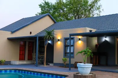 a house with a swimming pool in front of it at Hamisi Manor Guest House in Midrand