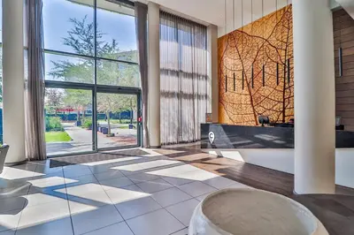a lobby with a large window and a large tub at 423 Menlyn maine Apartment in Pretoria