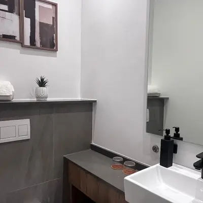 a bathroom with a sink and a mirror at 423 Menlyn maine Apartment in Pretoria