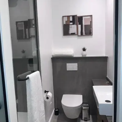 a bathroom with a white toilet and a sink at 423 Menlyn maine Apartment in Pretoria