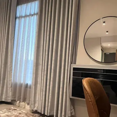 a room with a window with curtains and a mirror at 423 Menlyn maine Apartment in Pretoria