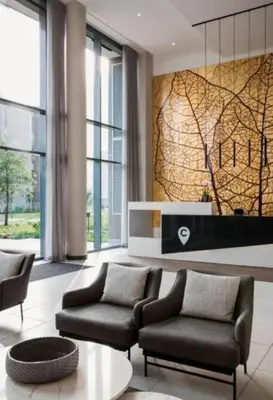 a living room with two chairs and a table at 423 Menlyn maine Apartment in Pretoria