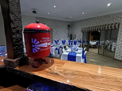 a red fire hydrant sitting on top of a table at Oppiplot Guest House Pty Ltd in Kempton Park