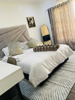 a bedroom with a bed and a desk and a chair at Marble Nights Guesthouse and spa Elim in Elim