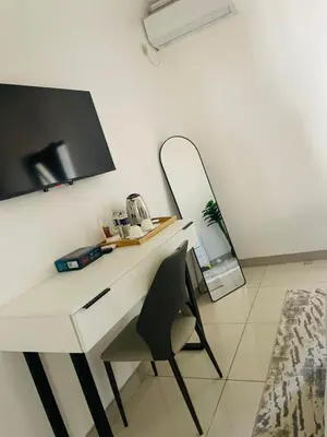 a white desk with a chair and a mirror at Marble Nights Guesthouse and spa Elim in Elim