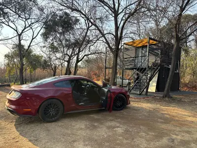 a small red car parked next to a playground at Harties Damview Resort in Hartbeespoort