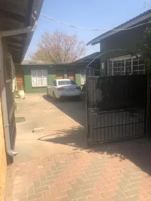 a white car parked in front of a house at Christland Guest House in Kempton Park