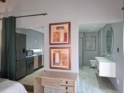 a bedroom with a bed and a bathroom with a sink at Apartment 1 at CView in Pretoria