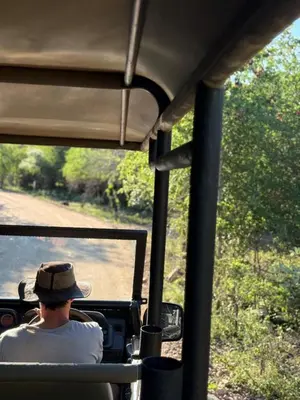 a man sitting in the back of a safari vehicle at Selukwe Safari Lodge in Marloth Park