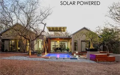 a house with a swimming pool in the yard at Amani Luxury Villa Marloth Park in Marloth Park
