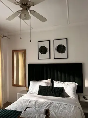 a bedroom with a bed and a ceiling fan at Luxury Airport Flatlet in Kempton Park