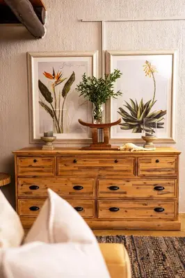 a wooden dresser with two plants on top of it at Karongwe - Noka House in Hoedspruit