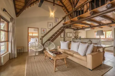 a living room with a couch and a table at Karongwe - Noka House in Hoedspruit