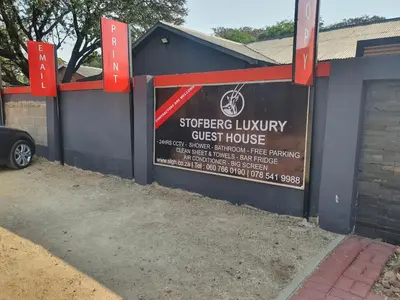 a building with a sign for a guest house at Stofberg Guest House in Brits