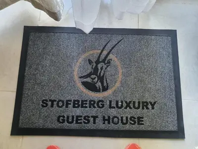 a sign for a guest house on a table at Stofberg Guest House in Brits