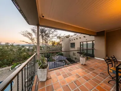 a balcony of a house with chairs and a view at 8 On Penny Guesthouse in Nelspruit