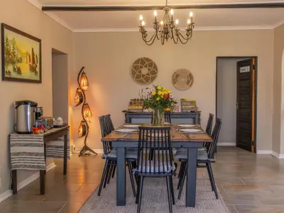 a dining room with a table and chairs at 8 On Penny Guesthouse in Nelspruit