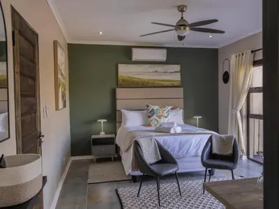 a bedroom with a bed and a ceiling fan at 8 On Penny Guesthouse in Nelspruit