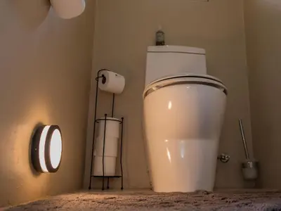 a bathroom with a white toilet in a room at 8 On Penny Guesthouse in Nelspruit