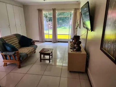 a living room with a couch and a table at La Siesta in Pretoria