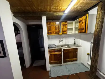 a kitchen with wooden cabinets and a sink at The Treehouse in Pretoria