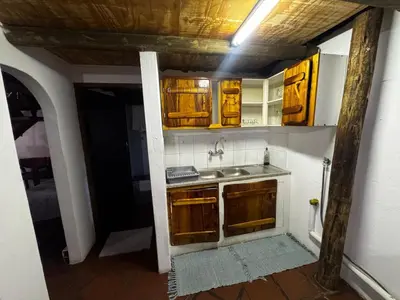 a kitchen with wooden cabinets and a sink at The Treehouse in Pretoria