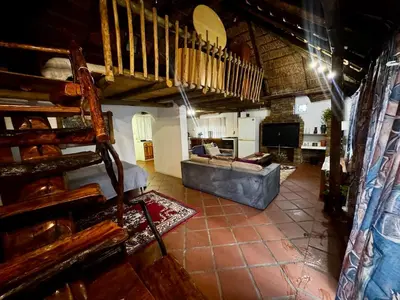 a large living room with a couch and a table at The Treehouse in Pretoria