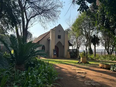 a church with a dirt road in front of it at Africa Skye Venue & Events in Pretoria