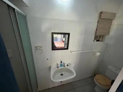 a bathroom with a sink and a toilet and a mirror at Africa Skye Venue & Events in Pretoria
