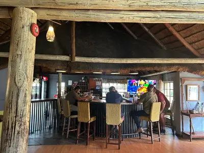 a group of people sitting at a bar in a restaurant at Africa Skye Venue & Events in Pretoria