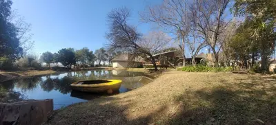 a yellow boat sitting on the side of a river at Africa Skye Venue & Events in Pretoria