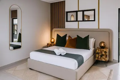 a bedroom with a large bed with two mirrors at Alldays Country Lodge in Alldays