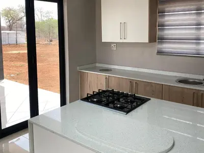 a kitchen with a stove and a counter top at Alldays Country Lodge in Alldays