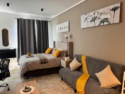a living room with two beds and a couch at Home at 422Trilogy Menlyn Maine in Pretoria