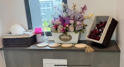 a counter with a vase of flowers on it at Home at 422Trilogy Menlyn Maine in Pretoria