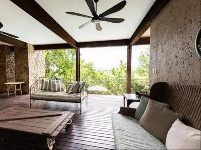 a living room with a couch and a ceiling fan at La Serenita @ Migdash in Hartbeespoort