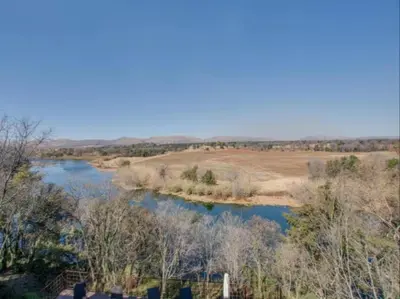 a river in the middle of a field at La Serenita @ Migdash in Hartbeespoort