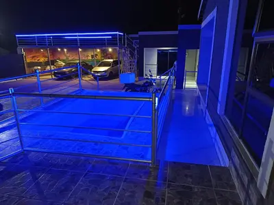 a view of a building at night with blue lights at Baraba's guest house in Nelspruit