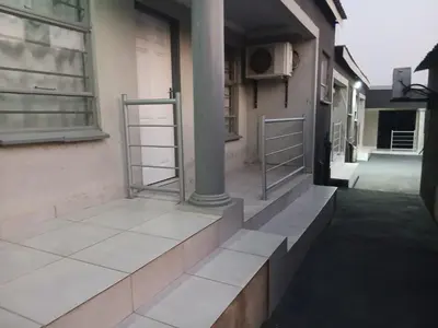a hallway of a building with two metal shelves at Baraba's guest house in Nelspruit