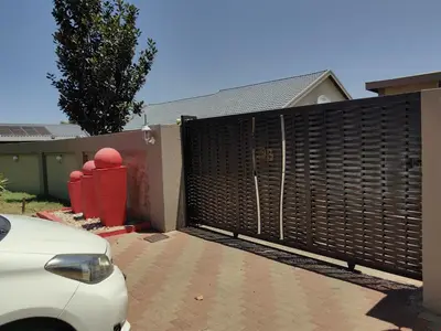 a wooden privacy fence in front of a house at Blackpony Guesthouse in Kriel
