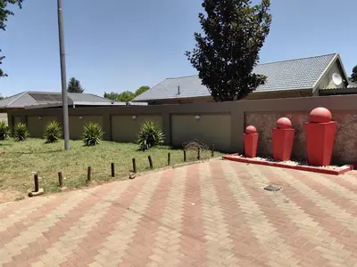 a house with a brick driveway in front of it at Blackpony Guesthouse in Kriel