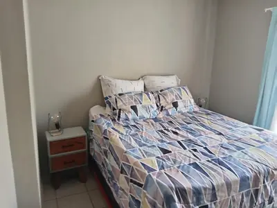 a bedroom with a bed and a night stand at Pretoria east N4 rest and drive in Pretoria