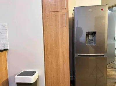 a stainless steel refrigerator with a trash can next to it at Luxurious 2 bedroom Apartment! in Centurion