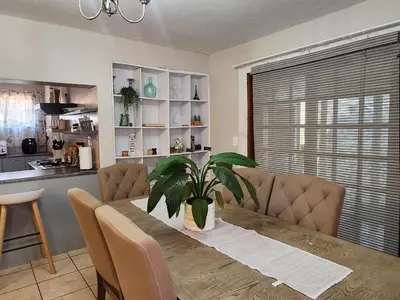 a dining room table with a plant on top of it at Pearl Palace in Polokwane